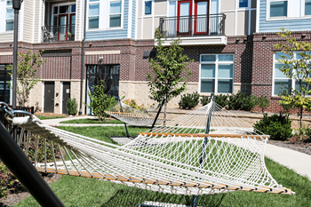 A white net is in the grass in front of a building.